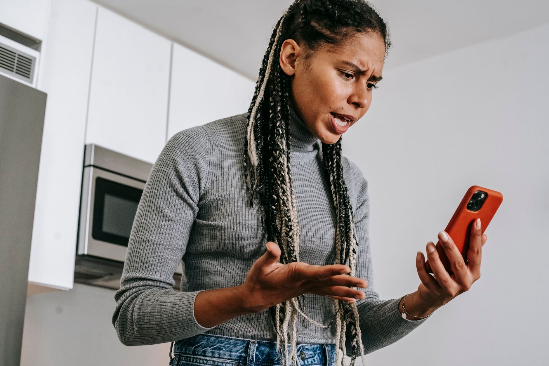 Woman frustrated by poor digital interface design on a smartphone app